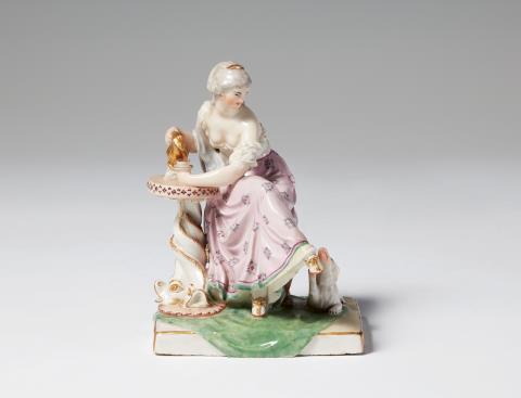 A small Ludwigsburg porcelain figure of a lady drinking coffee