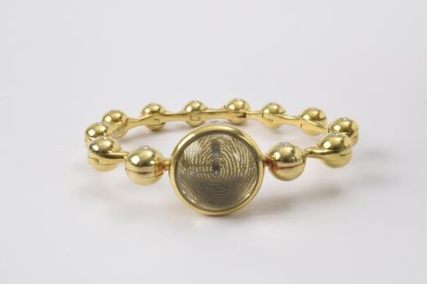 Max Pollinger - An 18k gold bracelet with a watch
