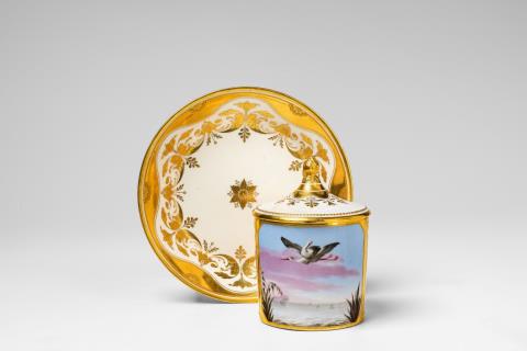 A Vienna porcelain cup and cover with a pair of storks