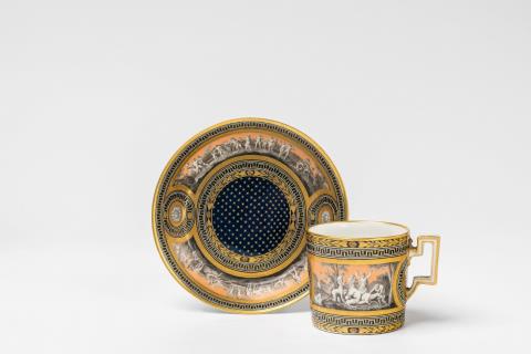 A Vienna porcelain cup and saucer with maenads