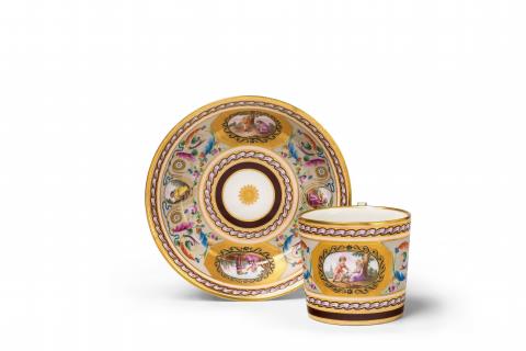 A Vienna porcelain cup and saucer with grotesques