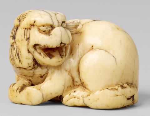 Carl Jutz the Elder - A small ivory netsuke of a recumbent shishi. 18th century