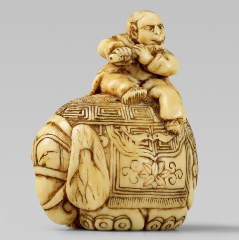 A small ivory netsuke of an elephant with a Chinese boy. Early 19th century