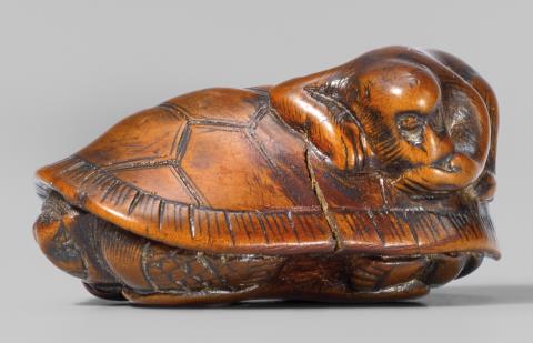 A boxwood netsuke of a tortoise and a monkey. First half 19th century