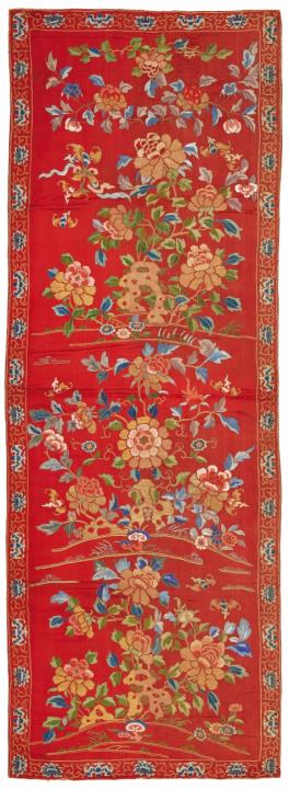 A long embroidered red satin panel, possibly a chair cover. Late 19th century