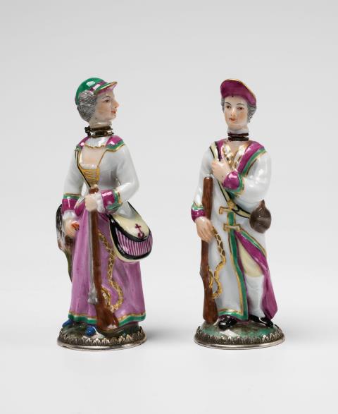 A pair of Ludwigsburg porcelain perfume bottles formed as hunters