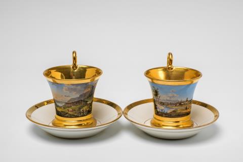 A pair of Nymphenburg porcelain cups with views of Bavaria