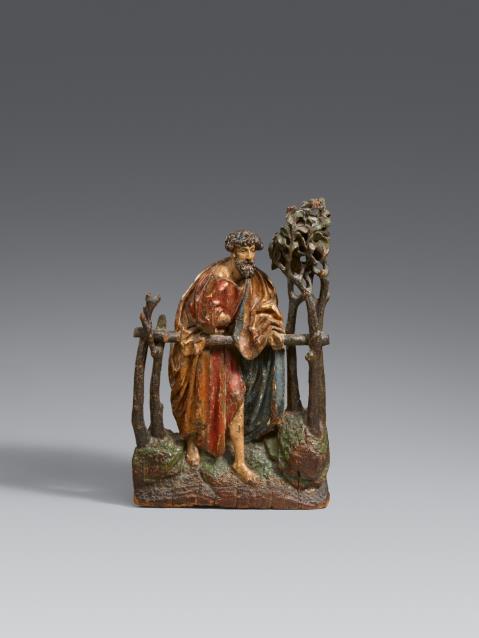 Probably Bavaria circa 1480/1490 - A carved wood relief of a saint in a garden, probably Bavarian, circa 1480/1490