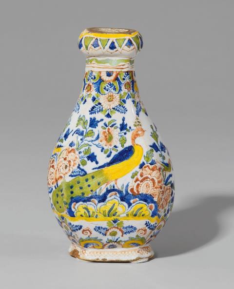 Gerhard Wolbeer - A small Berlin faience vase with peacock decor