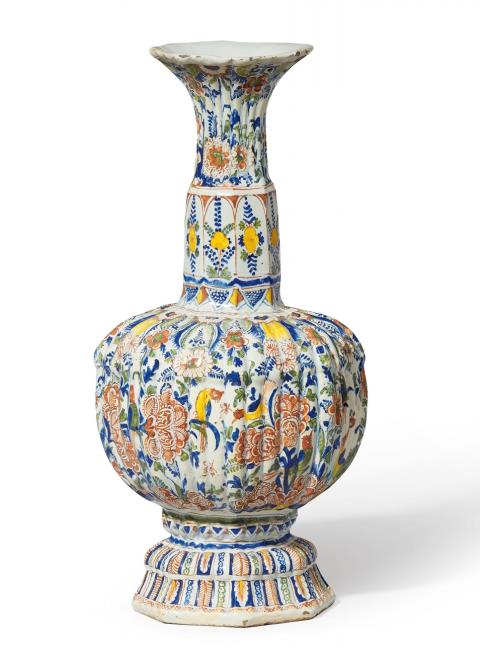 Gerhard Wolbeer - A ribbed Berlin faience vase with peacock decor