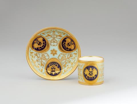 A Vienna porcelain cup and saucer with gold cornucopia motifs