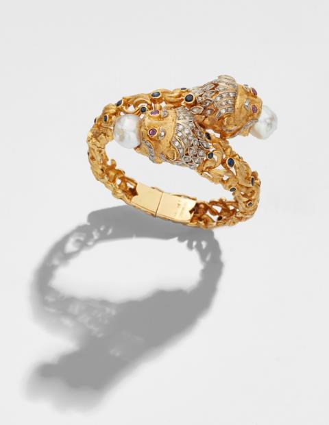 Ilias Lalaouins - An 18k gold pearl and coloured stone bangle with lion's head motifs