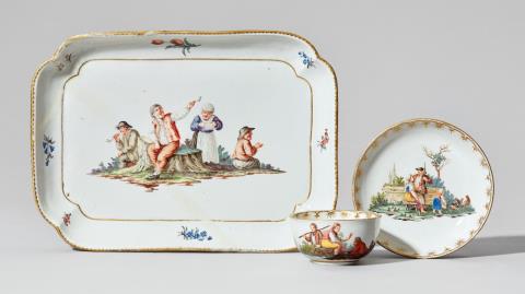 A Nymphenburg porcelain platter, cup, and saucer with peasant scenes