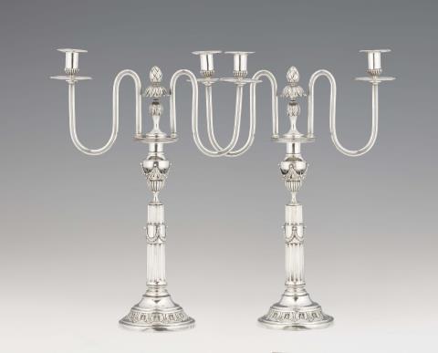 August Ferdinand Gentzmer - A pair of Berlin silver Louis XVI two flame candelabra