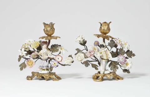 Johann Joachim Kaendler - A pair of gilt bronze candlesticks with Meissen porcelain figures