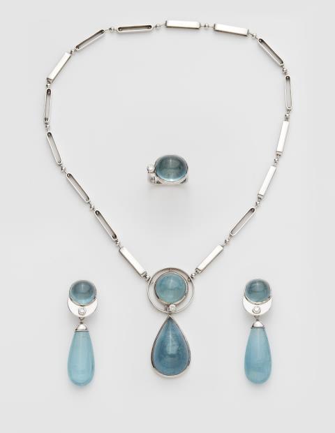 Hans-Leo Peters - A German 18k white gold diamond and aquamarine cabochon suite comprising a pendant necklace, a pair of earrings and a ring.