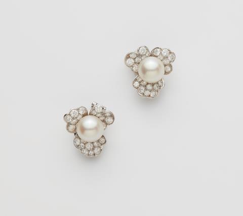 René Kern - A pair of German 18k white gold diamond and South sea pearl clip earrings.