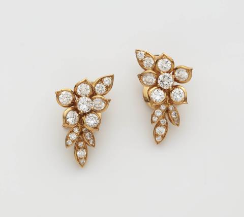  Van Cleef & Arpels - A pair of 18k gold and diamond clip earrings.