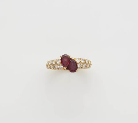  Van Cleef & Arpels - A French 18k gold diamond and pear-cut ruby band ring.