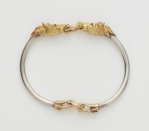 A silver and 18k gold horse head bangle.
