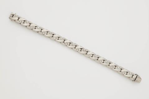 A German solid 18k white gold and diamond chain bracelet.