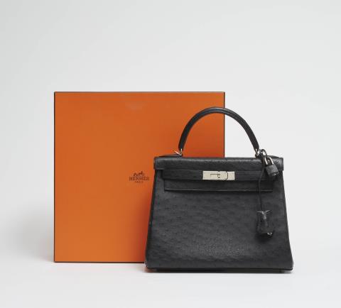  Hermès - A black ostrich leather Hermès Kelly bag 28 with silver palladium hardware.