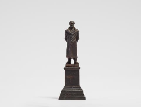 A cast iron miniature statuette of Goethe in a house coat
