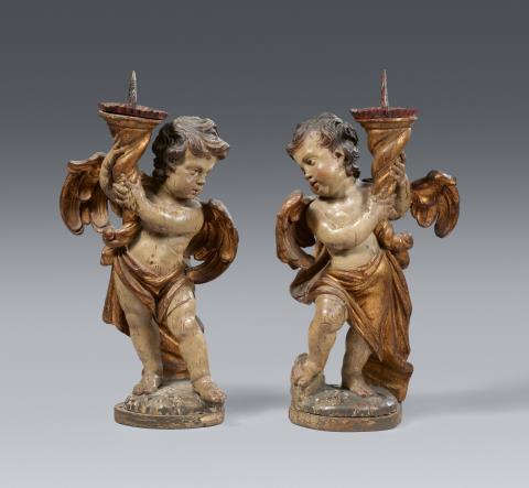 South German 18th century - A pair of carved wooden angels with candlesticks, Southern Germany, 18th century