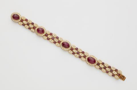  Van Cleef & Arpels - A French 18k gold "Mona" diamond and ruby cabochon bracelet.