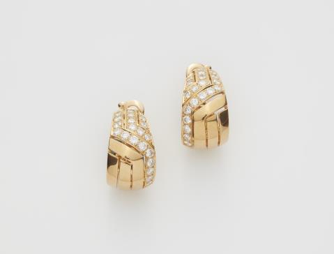 Cartier - A pair of 18k "Fami" Cartier diamond clip earrings.