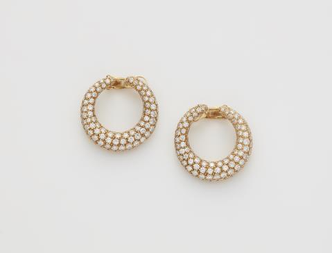 Cartier - A pair of French 18k gold and diamond pavé hoop clip earrings.
