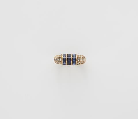  Van Cleef & Arpels - A French 18k gold diamond and sapphire eternity ring.