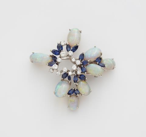 René Kern - An 18k white gold sapphire diamond and opal clip brooch.