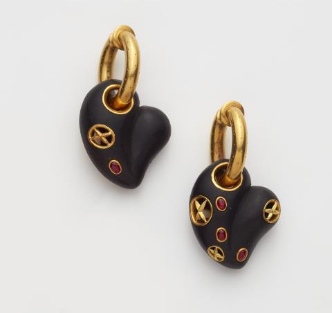 Otto Jakob - A pair of 18kt gold hoop earrings with ruby set carved ebony heart pendants.