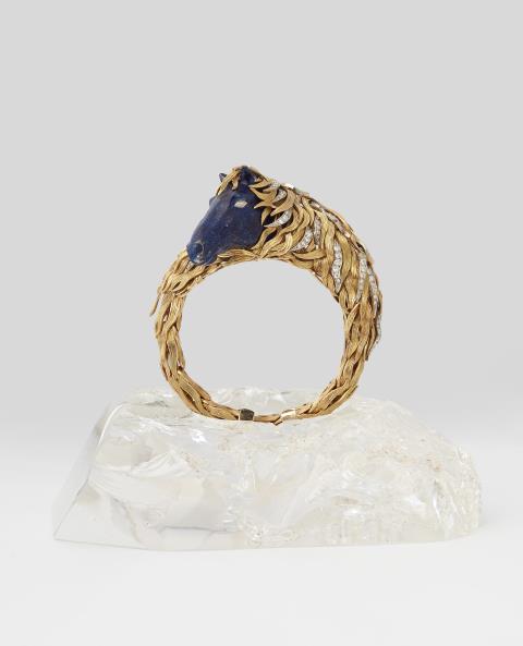 René Kern - A rare German 18k gold enamel and diamond horse bangle with rock crystal pedestal.