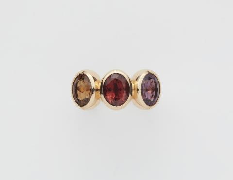 Goldsmiths Leser - A German 18k gold and coloured tourmaline three stone ring.