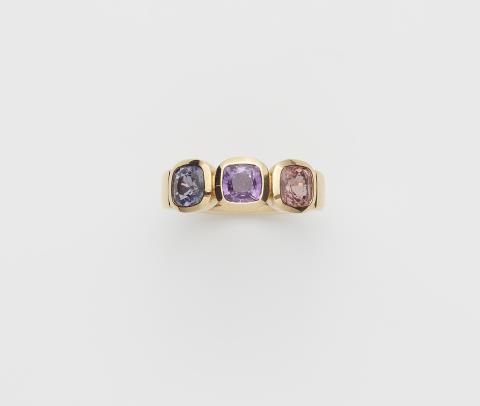 Goldsmiths Leser - A German 18k gold and coloured sapphire three stone ring.