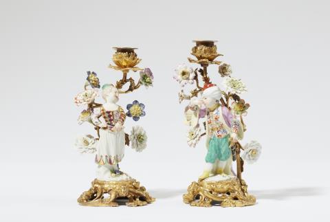  Meissen Royal Porcelain Manufactory - A pair of ormolu candlesticks mounted with Meissen porcelain figures of children in costumes