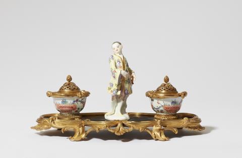 Meissen Royal Porcelain Manufactory - A Parisian ormolu writing set with a Meissen porcelain figure