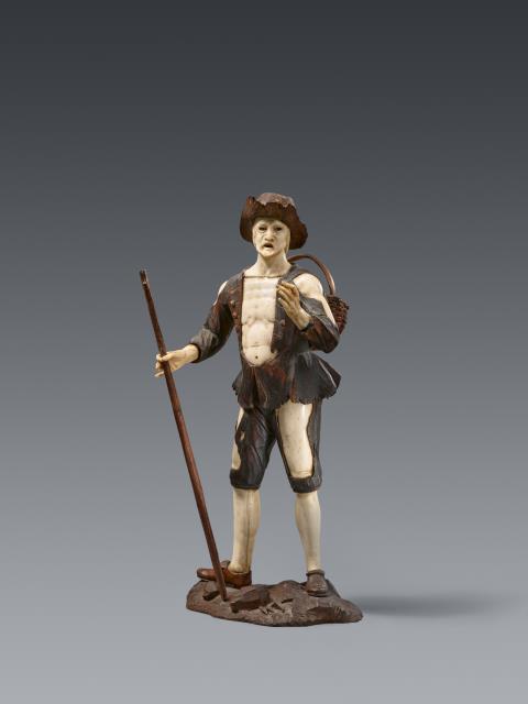 Simon Troger - A carved ivory figure of a travelling peddlar, attributed to Simon Troger